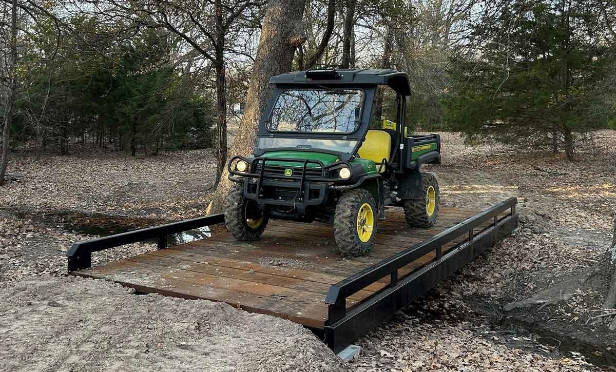 Utility bridge with galvanized finish and plate deck for equipment crossing.